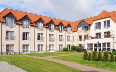 Der Neubau einer Health-Care-Immobilie mit Satteldach aus orangenen Dachziegeln. Die moderne Pflegeimmobilie erfüllt nach sachkundiger Begutachtung von Immobilienbewertung Westenberger alle Anforderungen einer Einrichtung für Pflege von Pflegebedürftigen.